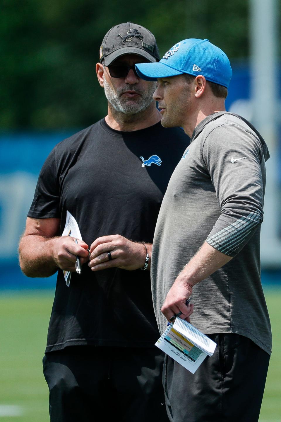 Lions offensive coordinator Ben Johnson, right, talks to special assistant to the owner and CEO Chris Spielman during minicamp at in Allen Park on Wednesday, June 7, 2023.