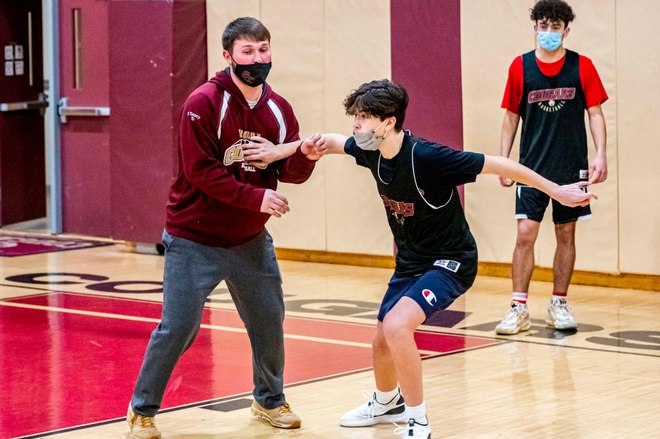 Old Colony assistant coach Paul Soucy trains Landon Hunter on getting open.