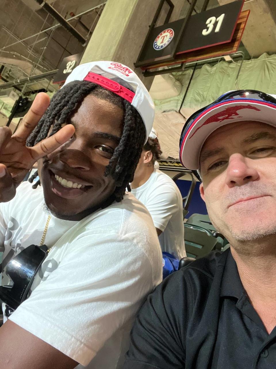 Chiefs receiver Rashee Rice, left, poses for a photo with SMU receivers coach Rob Likens during a Texas Rangers game in Arlington, Texas.