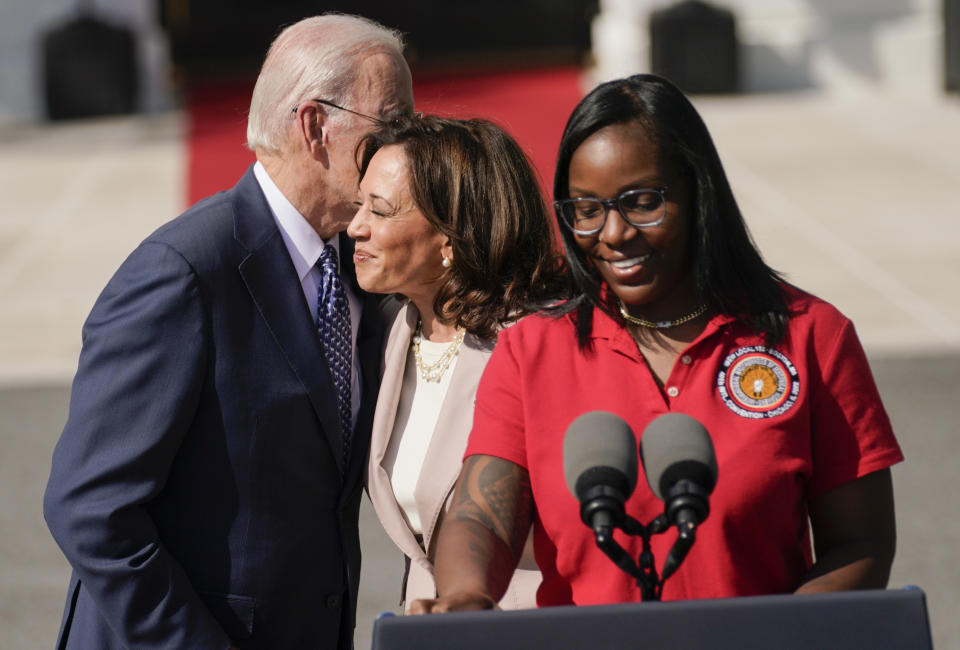 President Joe Biden hugs Vice President Kamala Harris as Lovette Jacobs, a fifth year IBEW Local 103 electrical apprentice in Boston, prepares to speak during a ceremony about the Inflation Reduction Act of 2022, on the South Lawn of the White House in Washington, Tuesday, Sept. 13, 2022. (AP Photo/Andrew Harnik)