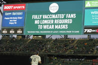 Fans sit in a special section for people who are fully vaccinated against COVID-19, at T-Mobile Park during a baseball game between the Seattle Mariners and the Detroit Tigers, Monday, May 17, 2021, in Seattle. Monday was the first day that fans fully vaccinated against COVID-19 were not required to wear masks at the ballpark, as shown on the video display. (AP Photo/Ted S. Warren)