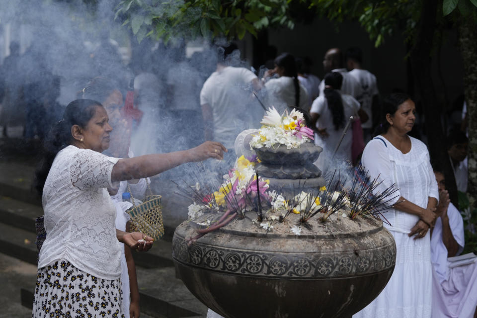 A Sri Lankan Buddhist devotee prays at a temple on the day of Buddha Poornima, or Vesak in Colombo, Sri Lanka, Thursday, May 23, 2023. In many parts of Asia, the sacred day marks not just the birth, but also the enlightenment and passing of the Buddha. (AP Photo/Eranga Jayawardena)