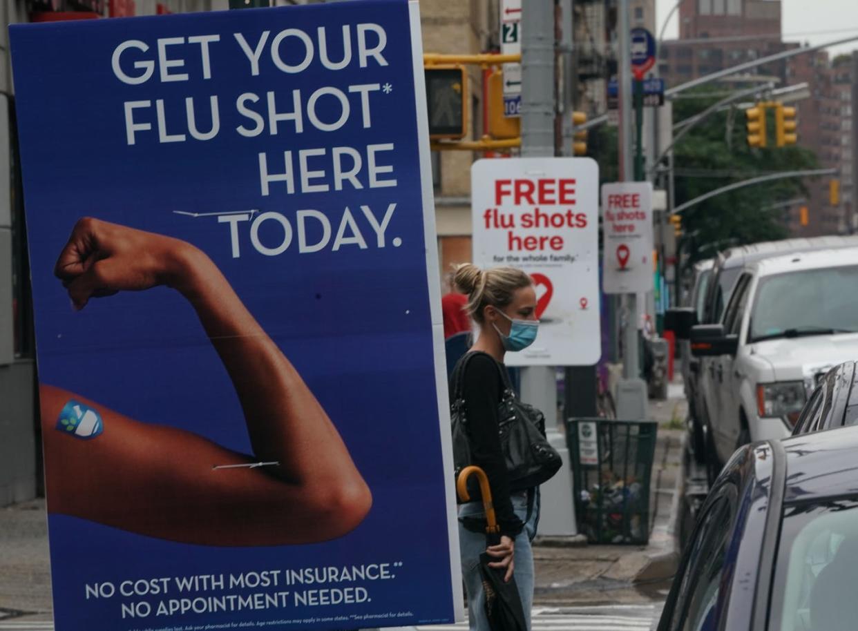 <span class="caption">Wouldn't it be nice if one shot could protect you for life?</span> <span class="attribution"><a class="link " href="https://www.gettyimages.com/detail/news-photo/woman-walks-past-free-flu-shot-advertisements-outside-of-news-photo/1228109098" rel="nofollow noopener" target="_blank" data-ylk="slk:Bryan R. Smith/AFP via Getty Images;elm:context_link;itc:0;sec:content-canvas">Bryan R. Smith/AFP via Getty Images</a></span>