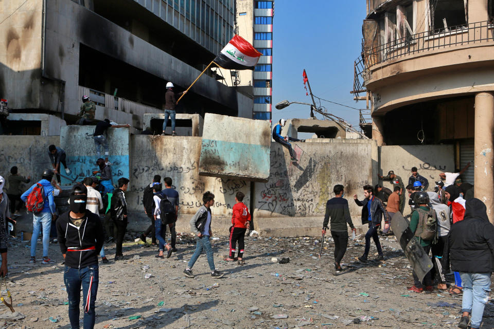 Anti-government protesters gather on Rasheed Street during clashes with security forces in Baghdad, Iraq, Tuesday, Nov. 26, 2019. (AP Photo/Khalid Mohammed)