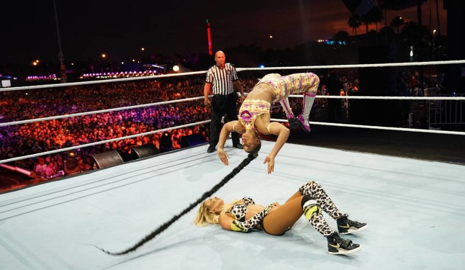 WWE SmackDown women’s champ The Est of WWE Bianca Belair back flips onto The Most Beautiful Woman in All of WWE Carmella during WWE Friday Night SmackDown on FOX from Roling Loud Miami outside Hard Rock Stadium in Miami Gardens. Your referee Darrick Moore.