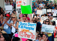 <p>Protesters hold signs at a rally for gun control at the Broward County Federal Courthouse in Fort Lauderdale, Florida on Feb. 17, 2018. (Photo: Rhona Wise/AFP/Getty Images) </p>