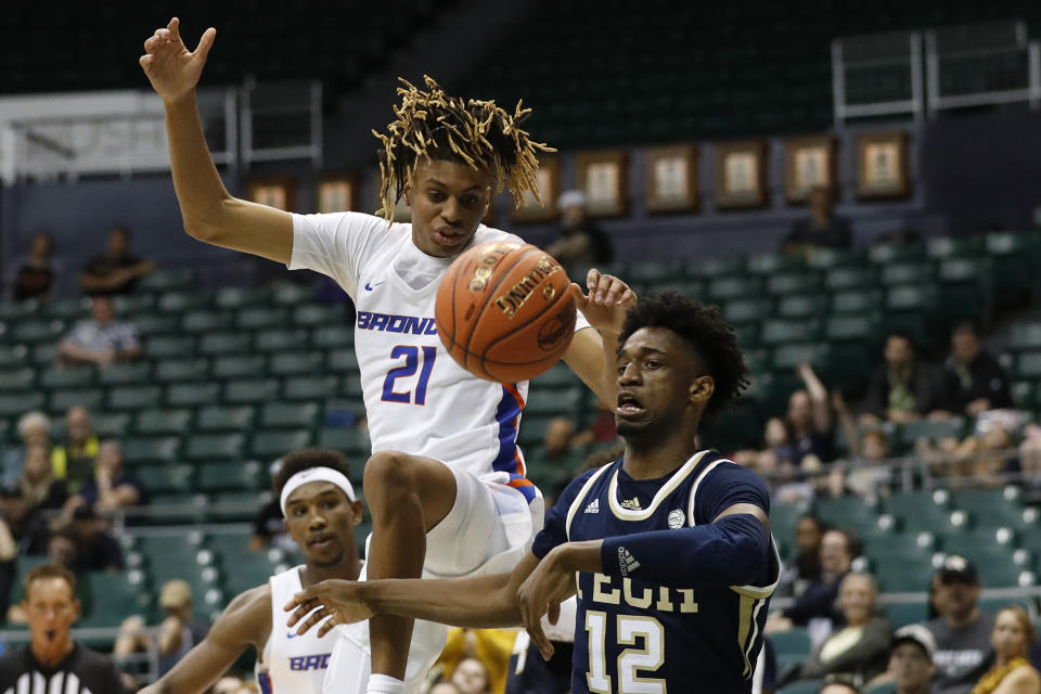 Boise State guard Derrick Alston (21) and Georgia Tech forward Khalid Moore (12) fight for a loose ball during the second half of an NCAA college basketball game Sunday, Dec. 22, 2019, in Honolulu. (AP Photo/Marco Garcia)