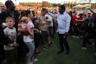 T.B. Joshua, a Nigerian evangelical preacher touches a man's head as he leads a religious retreat on Mount Precipice, Nazareth