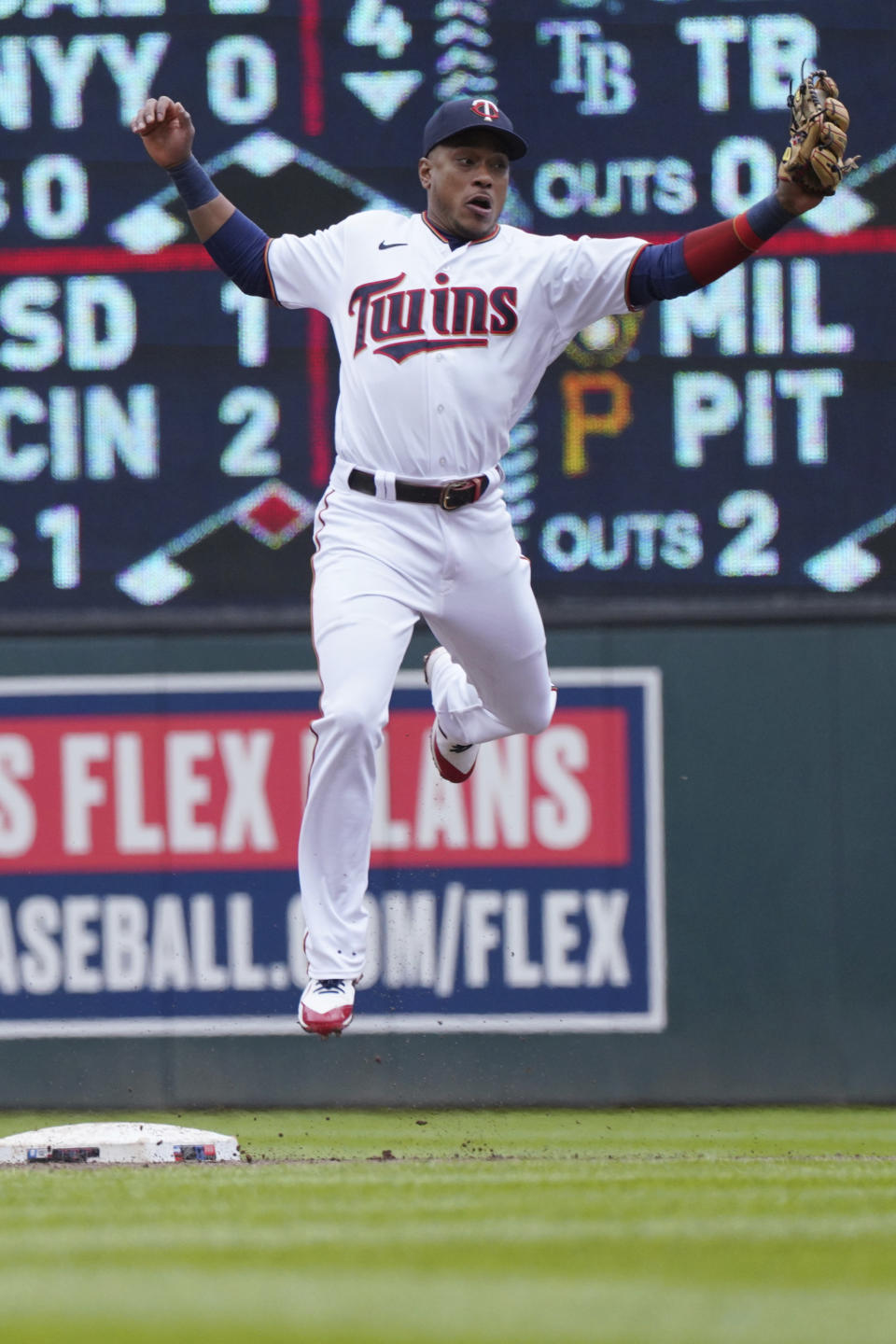 Minnesota Twins second baseman Jorge Polanco goes high for the throw on a successful steal by Detroit Tigers' Jonathan Schoop in the fourth inning of a baseball game, Thursday, April 28, 2022, in Minneapolis. (AP Photo/Jim Mone)
