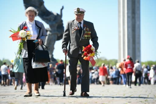 Members of Latvia's Russian minority gather at the Victory Monument to mark 73 years since the end of World War II