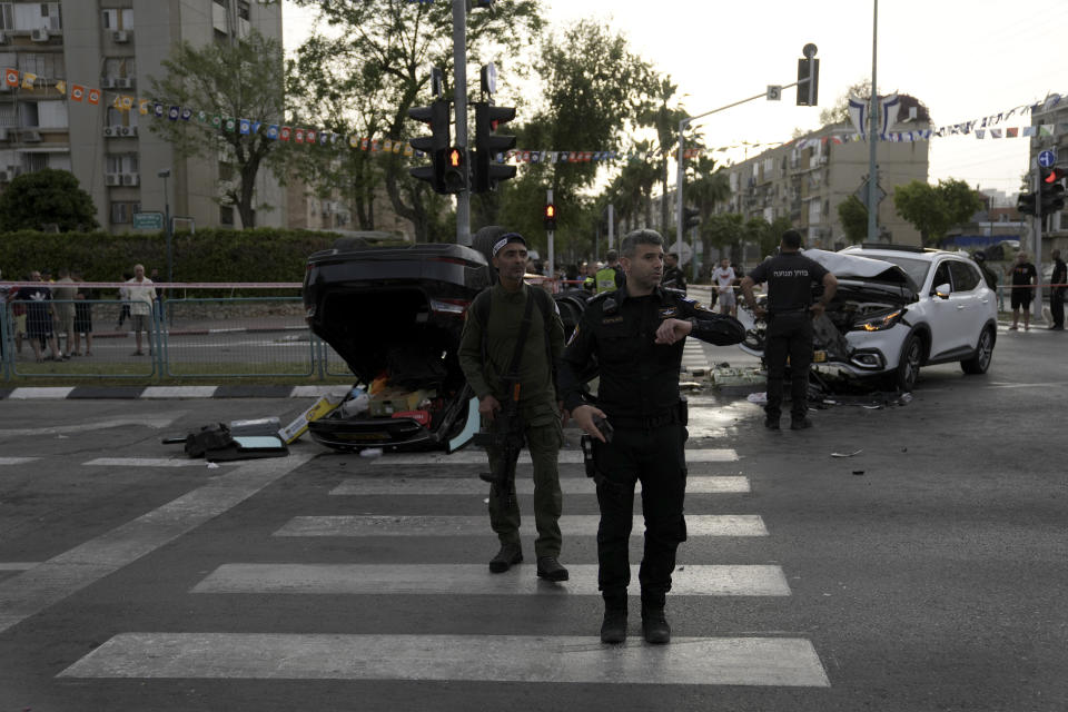 Israeli police investigate an accident with the car that had been carrying Israel's firebrand National Security Minister Itamar Ben-Gvir in Ramle, central Israel, Friday, April 26, 2024. Ben-Gvir was injured in a car accident and brought to the hospital Friday shortly after visiting the scene of a stabbing attack in central Israel, Israeli police say. (AP Photo/Mahmoud Illean)