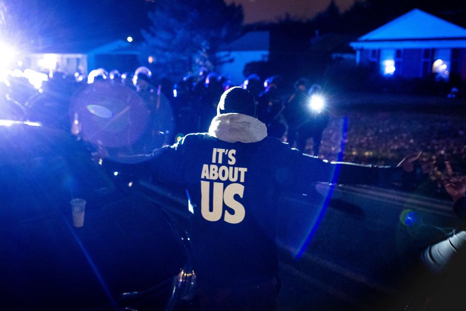 Chris Wells confronts Louisville police as protesters, seeking racial justice for Breonna Taylor and angered by recent developments regarding the grand jury trial and attorney general Daniel Cameron, organized a protest outside his residence Saturday evening. Oct. 24, 2020