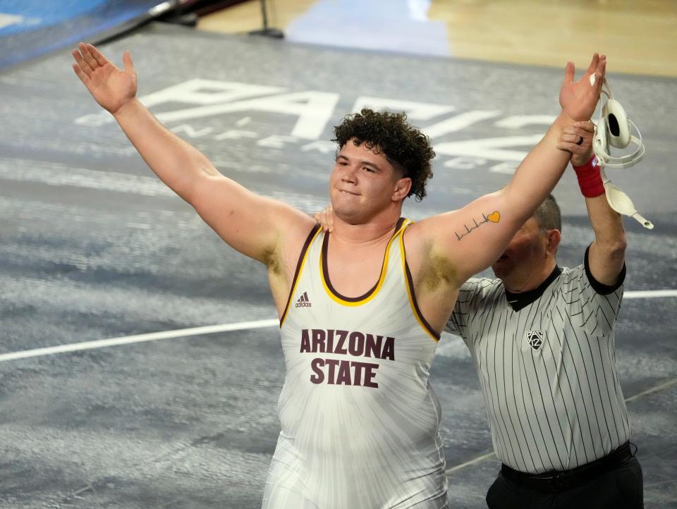 Mar 6, 2022; Tempe, Arizona, U.S.;  Arizona State's Cohlton Schultz celebrates his victory over Oregon State's Gary Traub in the heavyweight class during the finals of the Pac-12 wresting championships at Desert Financial Arena.