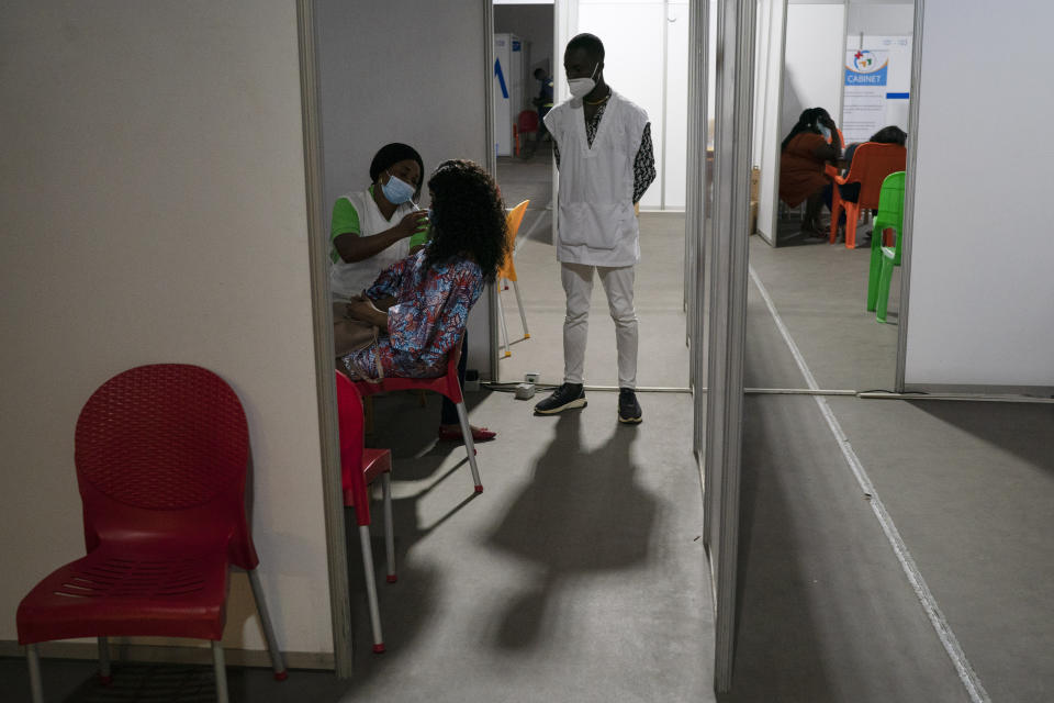 A health worker administers a dose of the AstraZeneca vaccine at the sport park of Treichville in Abidjan, Ivory Coast, Wednesday, June 16, 2021. Africa's 1.3 billion people account for 18% of the world’s population. But the continent has received only 2% of all vaccine doses administered globally. (AP Photo/Leo Correa)