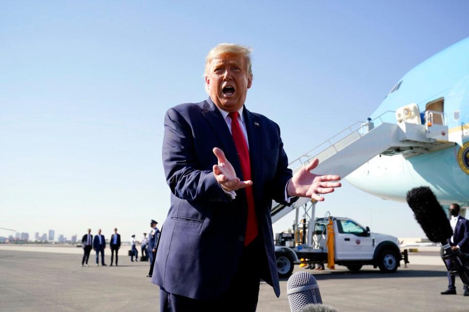 President Donald Trump speaks to reporters at Phoenix Sky Harbor International Airport on Oct. 19, 2020, in Phoenix.
