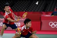 <p>China's Wang Yilyu (L) hits a shot next to China's Huang Dongping in their mixed doubles badminton semi-final match against Japan's Arisa Higashino and Japan's Yuta Watanabe during the Tokyo 2020 Olympic Games at the Musashino Forest Sports Plaza in Tokyo on July 29, 2021. (Photo by Alexander NEMENOV / AFP)</p> 