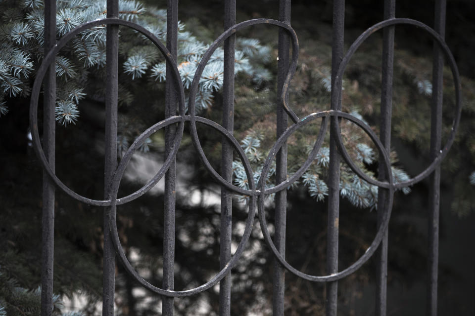 FILE - In this Monday, Dec. 9, 2019 file photo a damaged Olympic ring on the gate of the Russian Olympic Committee building in Moscow, Russia. The ruling on whether Russia can keep its name and flag for the Olympics will be announced on Thursday Dec. 17, 2020. The Court of Arbitration for Sport said Wednesday that three of its arbitrators held a four-day hearing last month in the dispute between the World Anti-Doping Agency and its Russian affiliate, known as RUSADA. (AP Photo/Pavel Golovkin, File)