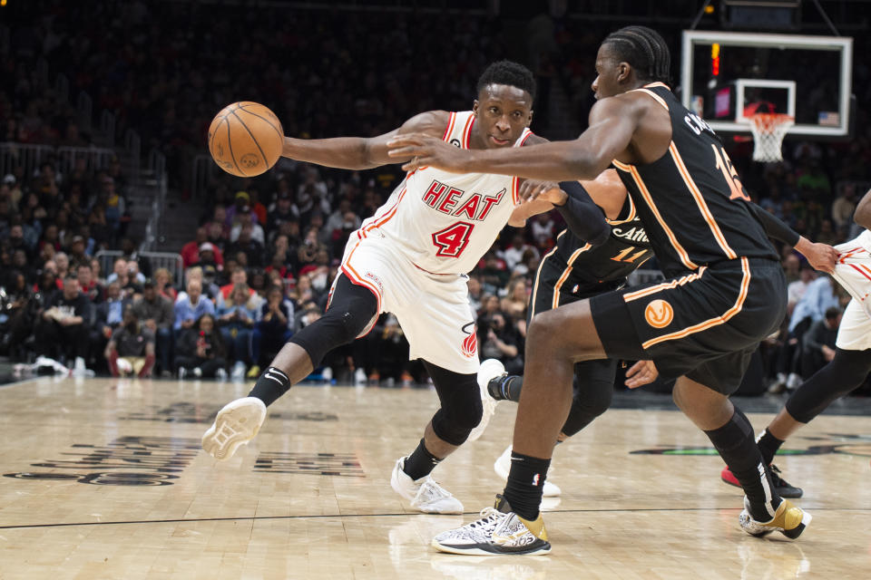 Miami Heat guard Victor Oladipo (4) drives against Atlanta Hawks center Clint Capela during the second half of an NBA basketball game, Monday, Jan. 16, 2023, in Atlanta. (AP Photo/Hakim Wright Sr.)