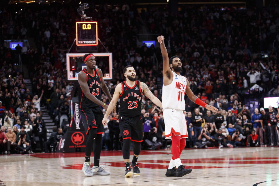 Toronto Raptors forward Pascal Siakam (43) and guard Fred VanVleet (23) watch as Brooklyn Nets guard Kyrie Irving (11) sinks the winning basket at the buzzer during the second half of an NBA basketball game in Toronto, Friday, Dec. 16, 2022. (Cole Burston/The Canadian Press via AP)