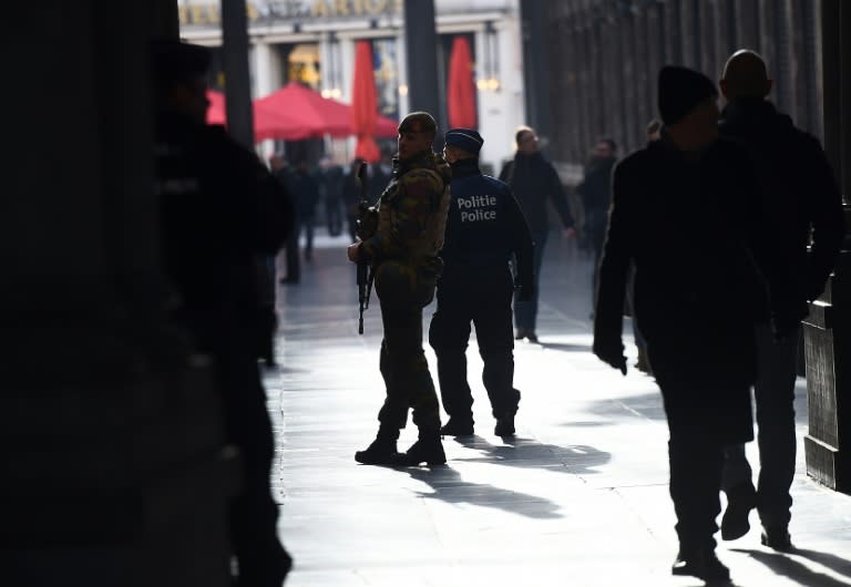 Soldiers and police patrol a nearly empty shopping mall as the Belgian capital remains on the highest possible alert level, in Brussels on November 23, 2015