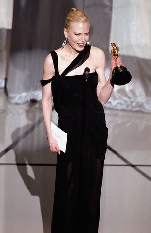 <p>courtesy of A.M.P.A.S. via Getty</p> Nicole Kidman accepts her award for Best Actress on March 23, 2003 in Hollywood, California.