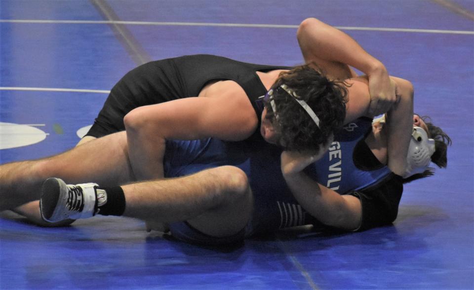 Little Falls Mountie Julius Schaffner tries to force Dolgeville Blue Devil Talan Jaquay onto his back during the third period of Wedneday's 172-pound bout in Dolgeville. Schaffner won with a pin while trailing 13-4 in the match.