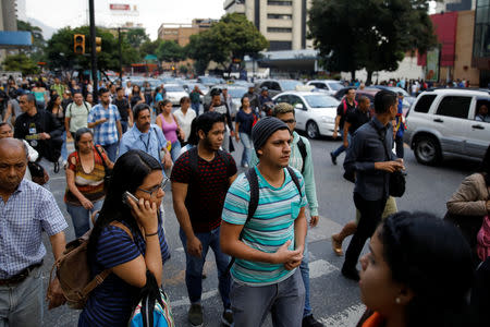 People walk on the street during a blackout in Caracas, Venezuela March 7, 2019. REUTERS/Carlos Garcia Rawlins