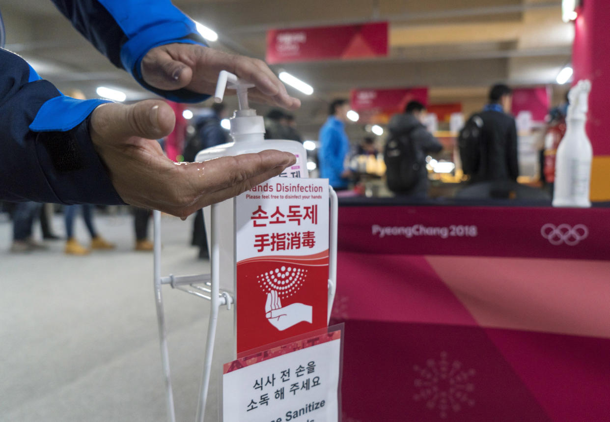 A man sanitizes his hands at the entrance to the media cafeteria in Gangneung, South Korea, Wednesday, Feb. 7, 2018. South Korean authorities deployed 900 military personnel at the PyeongChang Olympics on Tuesday after the security force was depleted by an outbreak of norovirus. (AP)
