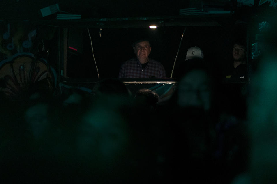 Ignacio Pineda, 60, founder of the iconic music and cultural venue Multiforo Cultural Alicia watches the show from a cabin during one of the last active weekends at the iconic venue in Mexico City, Friday, Feb. 24, 2023. “Nobody came at the beginning. It was a tiny place, uncomfortable, very punk.” recalls Pineda. “But I didn't want a trendy bar. I wanted a place for the people." He said. (AP Photo/Eduardo Verdugo)