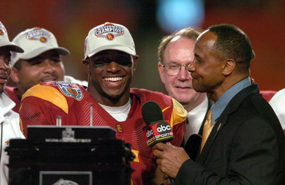 USC running back Reggie Bush is interviewed by ABC broadcaster Lynn Swann following the Trojans' 55-19 victory over Oklahoma in the BCS national championship game on January 4, 2005 at the Orange Bowl.  Bush won the Heisman Trophy the following season.