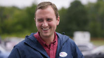 New Hampshire Republican 1st Congressional District Candidate Matt Mowers smiles while talking with voters and campaign volunteers, Tuesday, Sept. 13, 2022, during a stop at a polling station in Derry, N.H. (AP Photo/Charles Krupa)