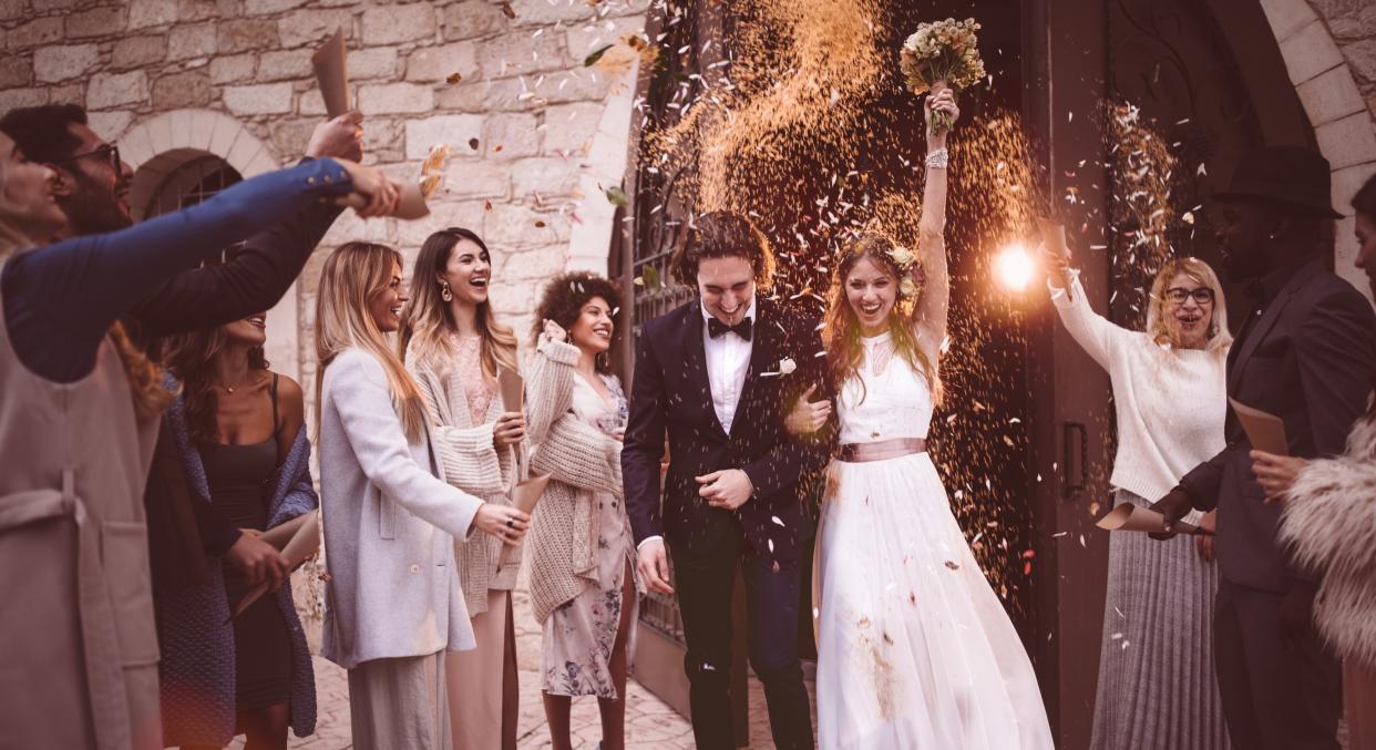 Couple pictured outside on their wedding day