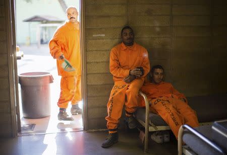 Prison inmates sit in their dormitory at Oak Glen Conservation Fire Camp #35 in Yucaipa, California November 6, 2014. REUTERS/Lucy Nicholson