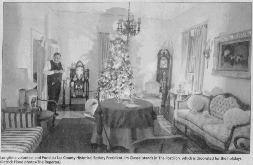 Then-Fond du Lac County Historical Society President Jim Glassel shows the holiday-decorated Postilion house in this 2011 file photo.