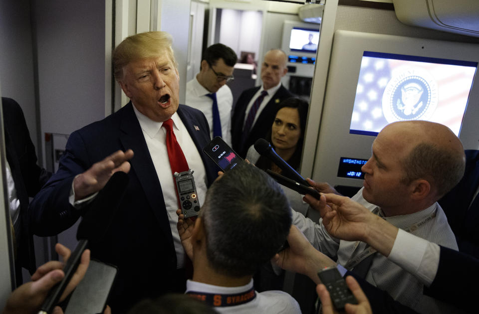 President Donald Trump talks to reporters aboard Air Force One after visiting Dayton, Ohio and El Paso, Texas, Wednesday, Aug. 7, 2019. (AP Photo/Evan Vucci)