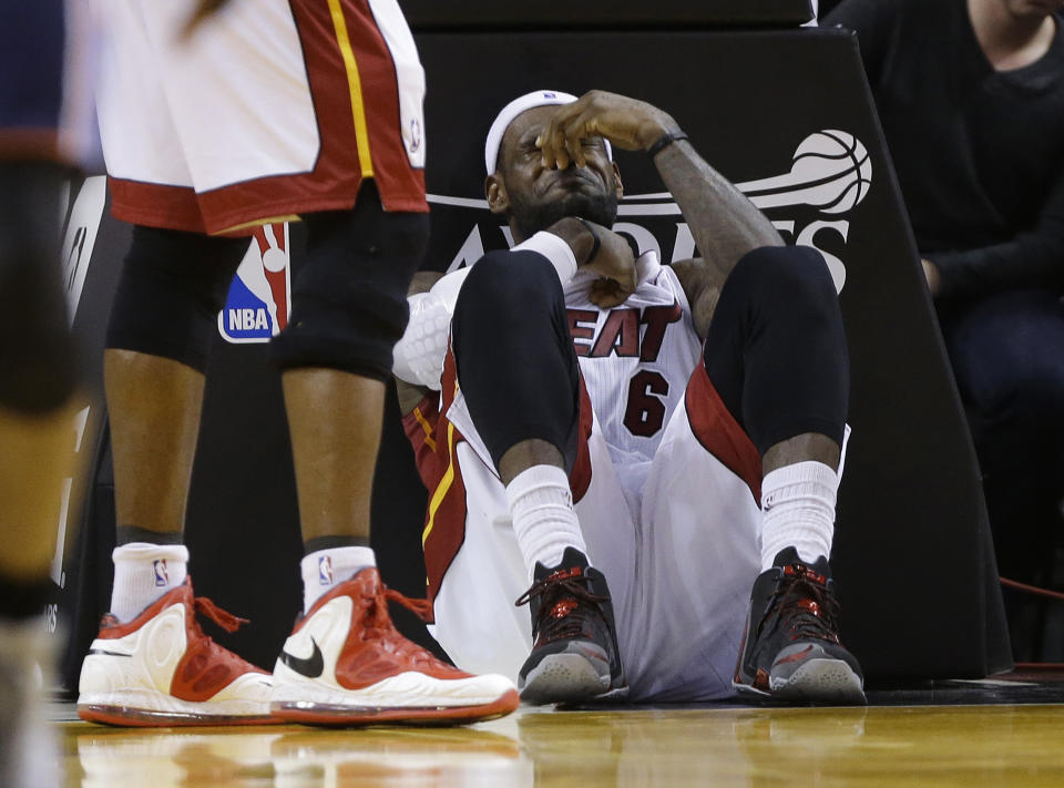 Miami Heat's LeBron James sits on the court after being elbowed by Charlotte Bobcats' Josh McRoberts during the second half in Game 2 of an opening-round NBA basketball playoff series, Wednesday, April 23, 2014, in Miami. The Heat defeated the Bobcats 101-97. (AP Photo/Lynne Sladky)