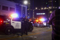 Los Angeles Police officers try to disperse rowdy fans outside of Staples Center, Sunday, Oct. 11, 2020, in Los Angeles, after the Lakers defeated the Miami Heat in Game 6 of basketball's NBA Finals to win the championship. (AP Photo/Christian Monterrosa)