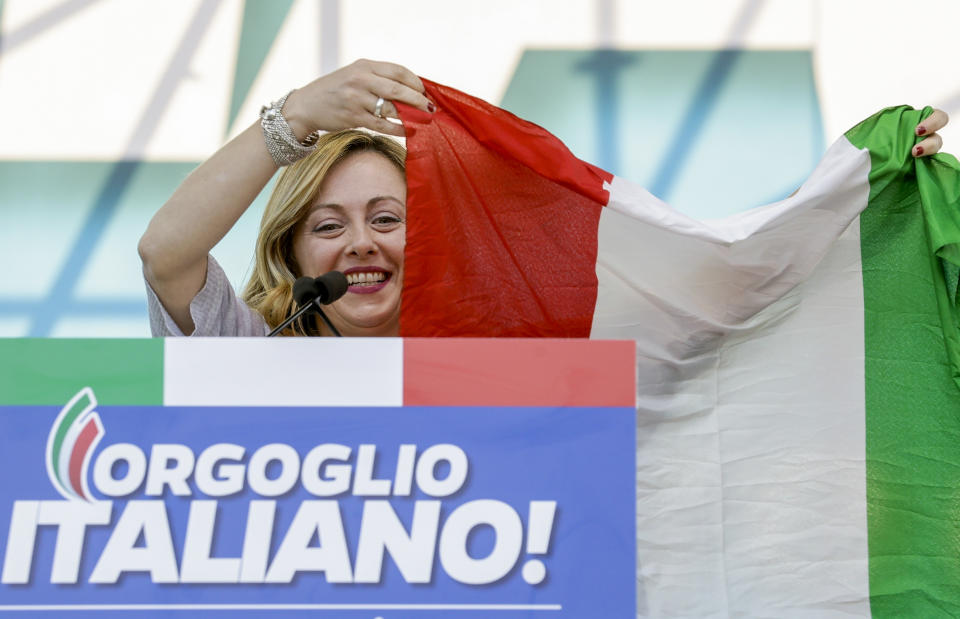 FILE — Giorgia Meloni holds an Italian flag as she addresses a rally in Rome, Saturday, Oct. 19, 2019. As a young teen, Italy's Giorgia Meloni embarked on an ideological quest that has propelled her to the verge of government power. The Sept. 25 election victory of her Brothers of Italy, a party with neo-fascist roots that she helped establish a decade ago, provided Meloni with a springboard into the Italian premiership. (AP Photo/Andrew Medichini)