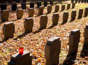 A candle is placed on a tombstone in a field of graves belonging to WWI soldiers in the main cemetery in Frankfurt, Germany, Saturday, Nov. 3, 2018. German Chancellor Angela Merkel will mark the 100th anniversary of the end of World War I on French soil, and President Frank-Walter Steinmeier will be in London’s Westminster Abbey for a ceremony with the queen. But in Germany, there are no national commemorations planned for the centenary of the Nov. 11 armistice that brought an end to the bloody conflict that killed more than 2 million of its troops and left 4 million wounded. That’s because the armistice did not bring peace to Germany. (AP Photo/Michael Probst)