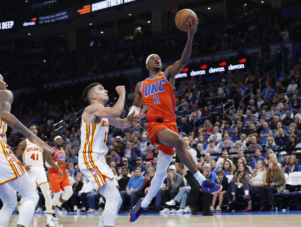 Nov 6, 2023; Oklahoma City, Oklahoma, USA; Oklahoma City Thunder guard Shai Gilgeous-Alexander (2) goes up for a basket against Atlanta Hawks guard <a class="link " href="https://sports.yahoo.com/nba/players/5338" data-i13n="sec:content-canvas;subsec:anchor_text;elm:context_link" data-ylk="slk:Bogdan Bogdanovic;sec:content-canvas;subsec:anchor_text;elm:context_link;itc:0">Bogdan Bogdanovic</a> (13) during the second half at Paycom Center. Oklahoma City won 126-117. Mandatory Credit: Alonzo Adams-USA TODAY Sports