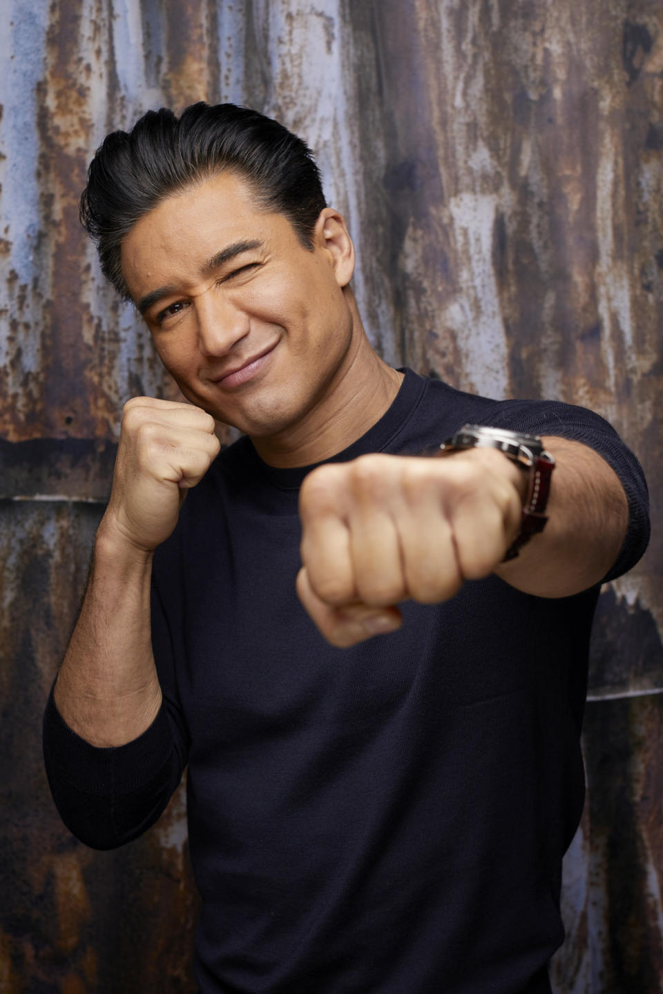 Closeup of Mario Lopez giving a fist bump