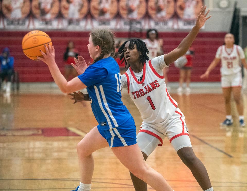 Lincoln's Touraya Blakey, right, guards Davis Sr. High's Izzy Cherry during an opening round game of the Sac-Joaquin Section girls basketball division 1 playoffs at Lincoln in Stockton on Feb. 14, 2024.