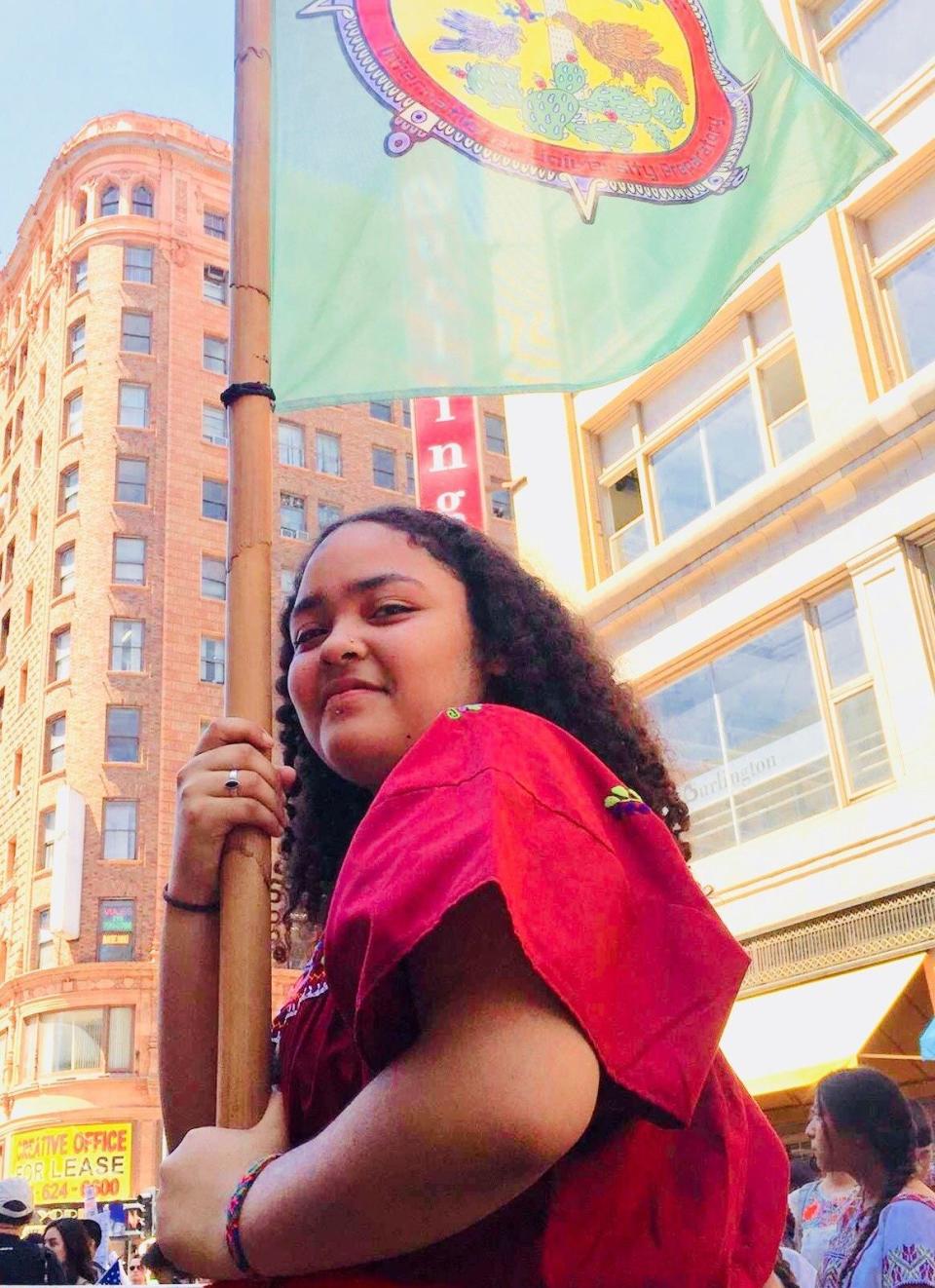 Ja-Rey Kilpatrick, in downtown Los Angeles during the May Day march for undocumented people, acts as a standard bearer for Semilla Community Schools. (Photo: Marcos Aguilar)