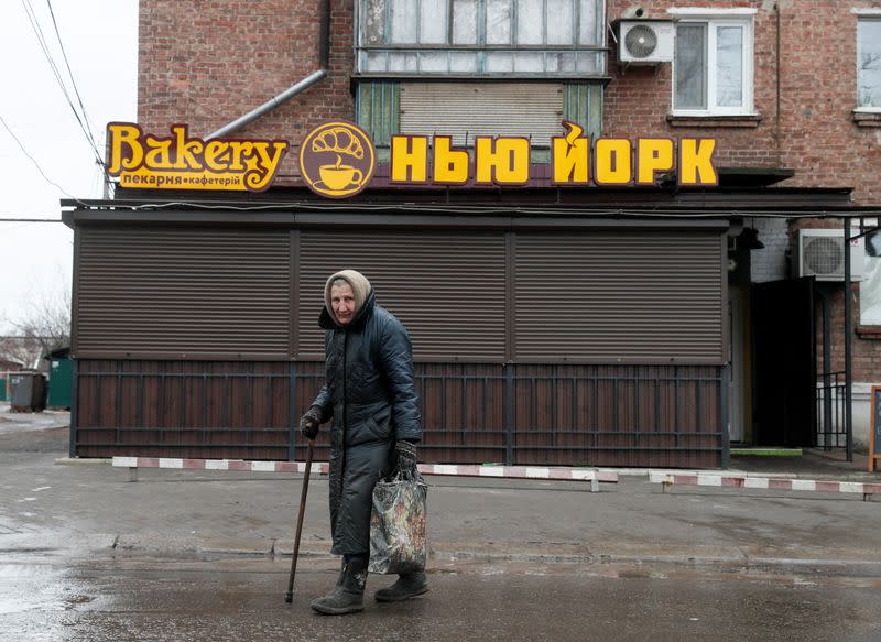 An elderly woman walks past a local bakery in Novhorodske