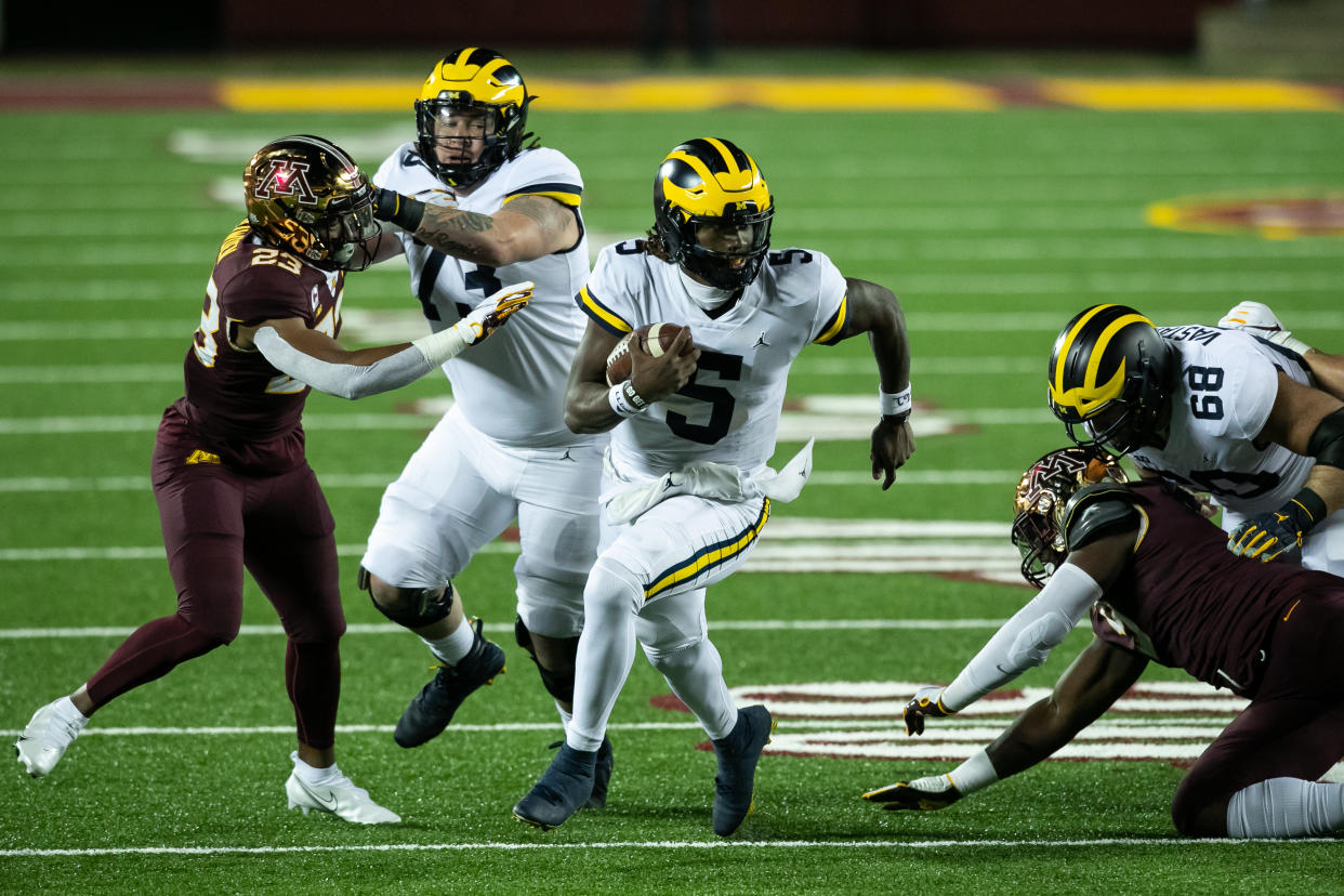 MINNEAPOLIS, MINNESOTA - OCTOBER 24: Joe Milton #5 of the Michigan Wolverines carries the ball against the Minnesota Golden Gophers in the second quarter of the game at TCF Bank Stadium on October 24, 2020 in Minneapolis, Minnesota. (Photo by David Berding/Getty Images)