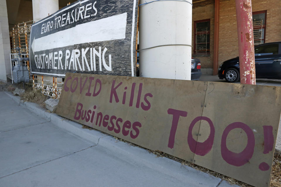 A "Covid kills businesses too" sign is shown outside Euro Treasures Antiques Friday, May 8, 2020, in Salt Lake City. Scott Evans is closing his art and antique store after 40 years. With a drastic drop in customers due to COVID-19 concerns and shelter-in-place orders, Evans says it was no longer cost effective to stay open. (AP Photo/Rick Bowmer)