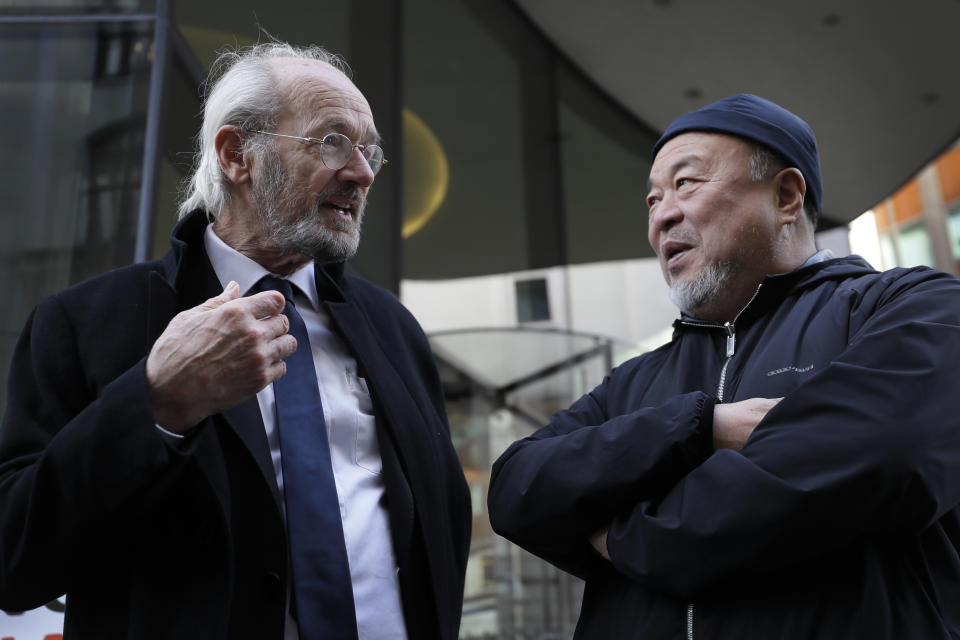 Chinese contemporary artist and activist Ai Weiwei speaks to John Shipton, biological father of Julian Assange outside the Old Bailey in support of Julian Assange's bid for freedom during his extradition hearing, in London, Monday, Sept. 28, 2020. (AP Photo/Kirsty Wigglesworth)