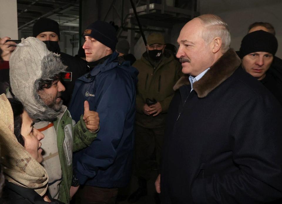 Belarusian president Alexander Lukashenko meets migrants as he visits the transport and logistics centre in Bruzgi on the Belarusian-Polish border (EPA)