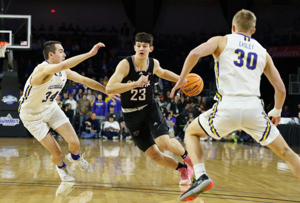 SIOUX FALLS, SD - MARCH 5: Frankie Fidler #23 of the Nebraska-Omaha Mavericks drives on Alex Arians #34 and Charlie Easley #30 of the South Dakota State Jackrabbits during the Summit League Basketball Tournament at the Denny Sanford Premier Center on March 5, 2022 in Sioux Falls, South Dakota. (Photo by Richard Carlson/Inertia)