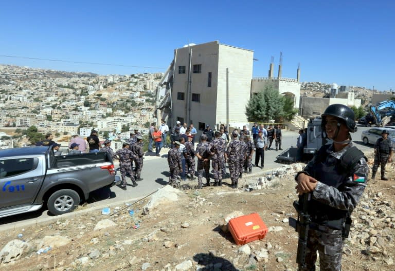 Jordanian security forces gather near a partially collapsed building in the town of Salt northwest of Amman a day after a deadly raid targeting militants